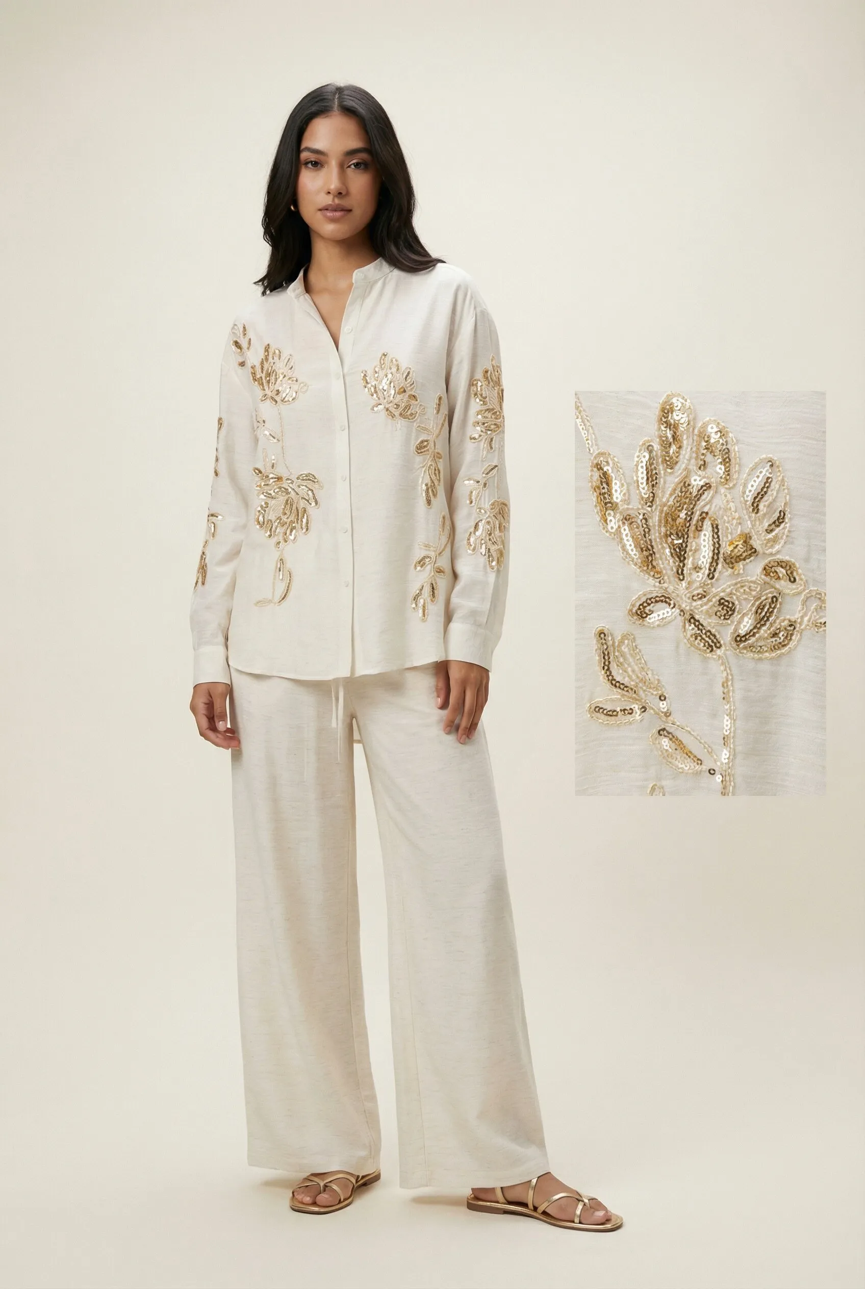 Generated with Kive.ai – young latin model in . she should wear flat gold strappy sandals. pants should reach the floor and sleeves should be till her wrists. product photo with a nice pose